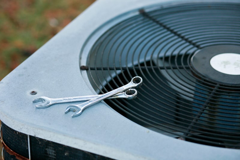 Wrenches on top of AC unit